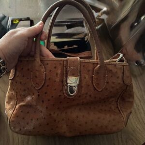 This is a vintage Dooney & Bourke brown ostrich leather purse handbag.